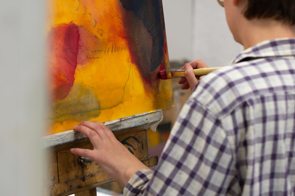 Student working on a painting