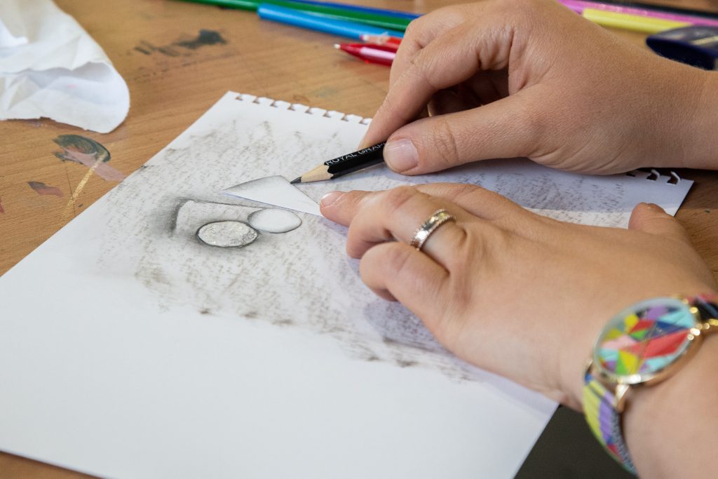 Student working on a pencil drawing