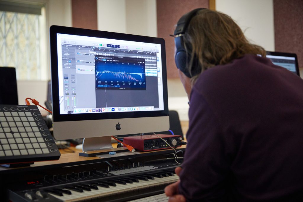 Student editing music on a screen