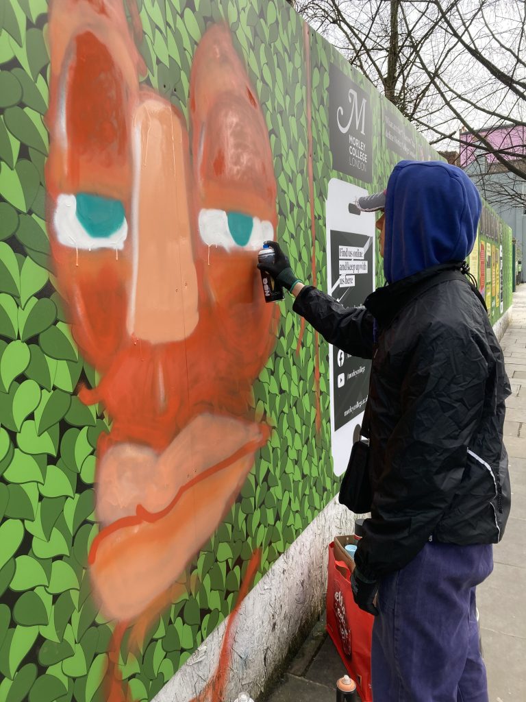 Artist Dino Dalle-Vacche adding street art to the North Kensington Green Wall