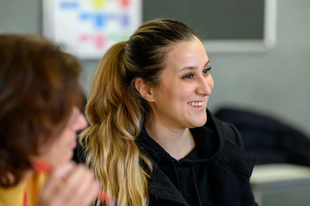 Young women smiling in class