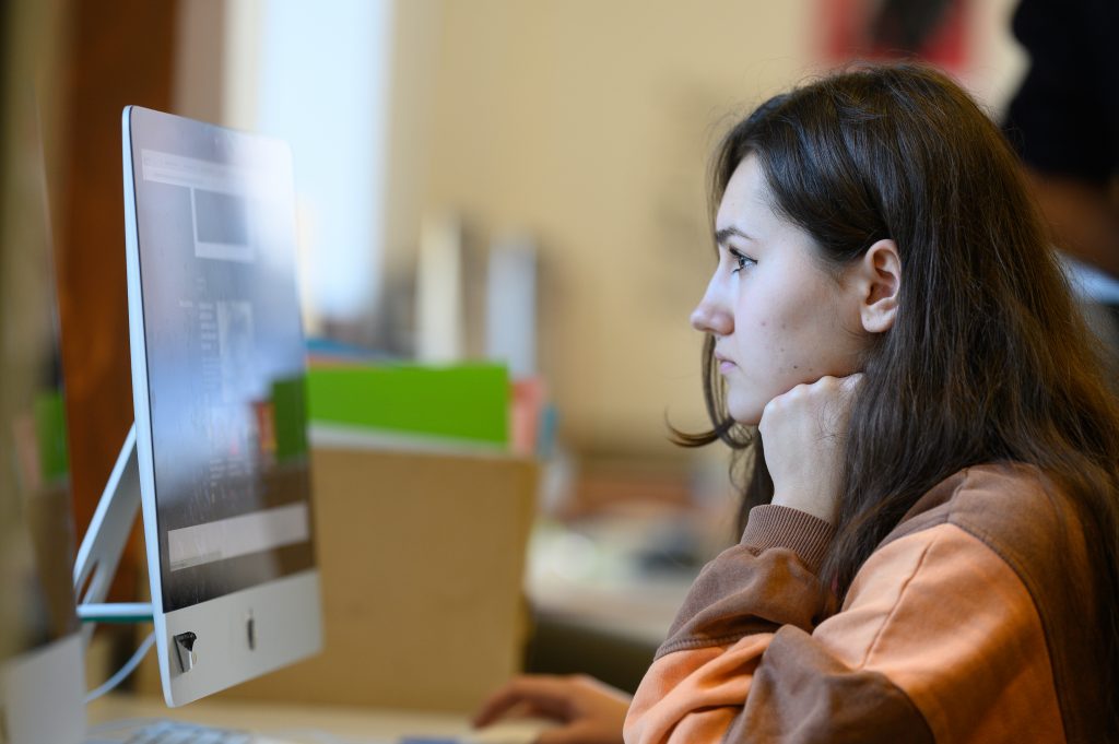 Young female student working on MAC. 