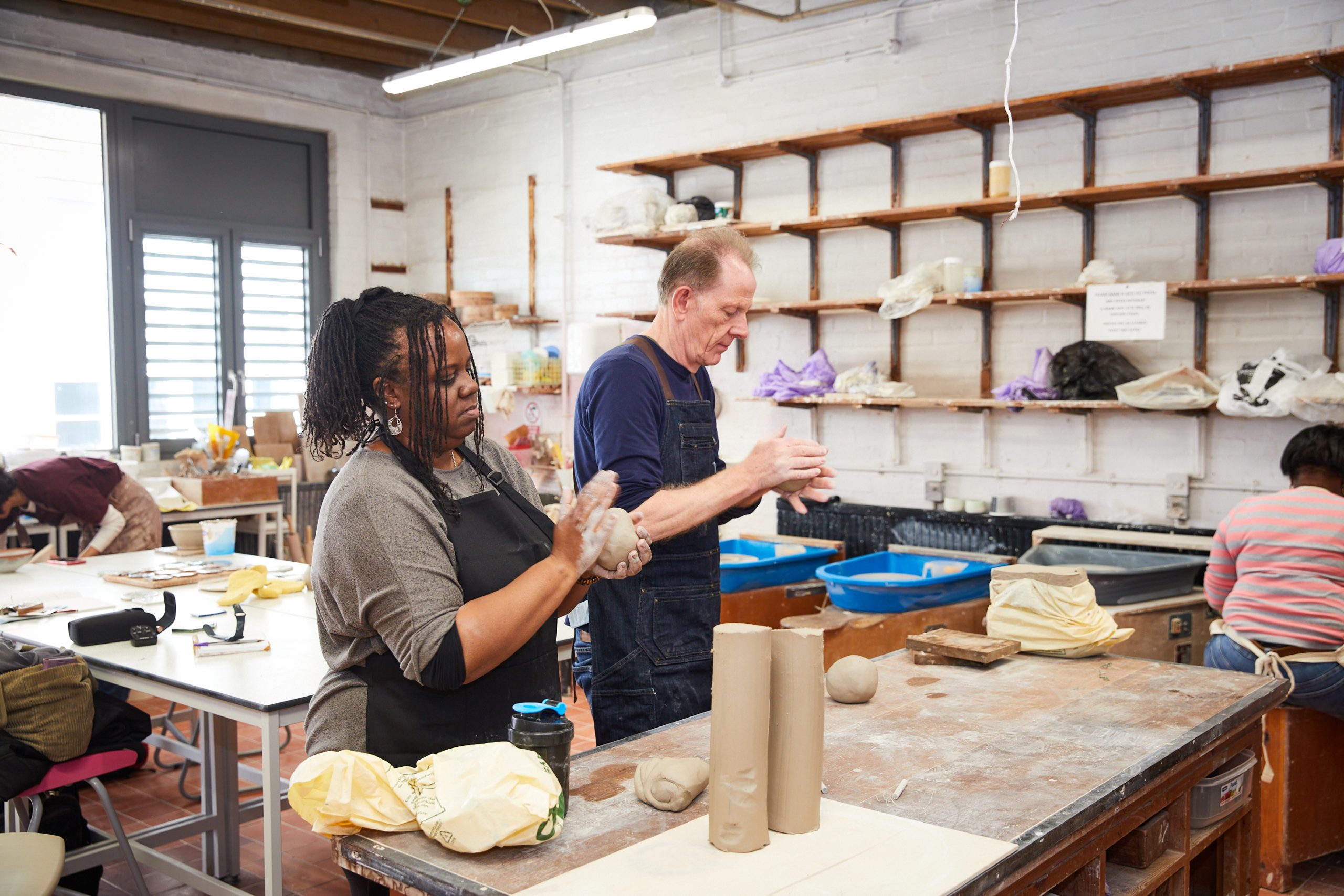 man and women in ceramics workshop