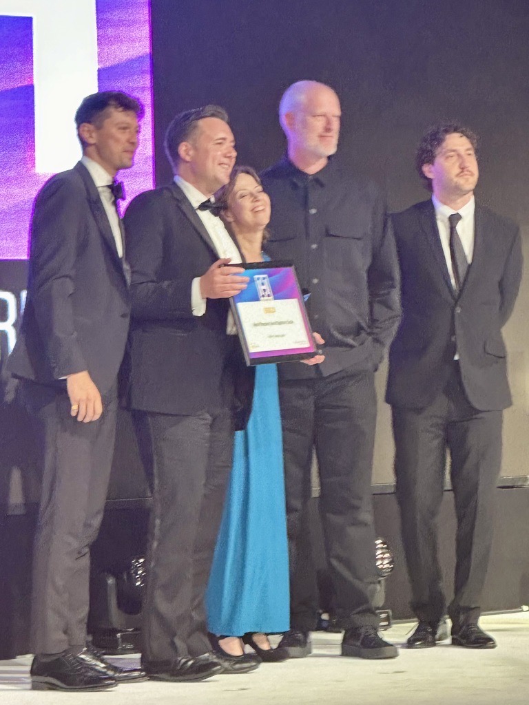 Staff members from Morley College London on stage receiving their Heist Award