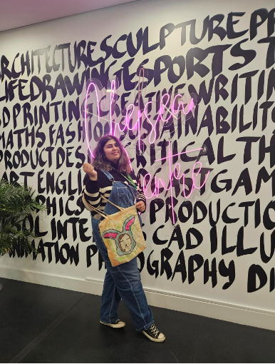 student holding tote bag