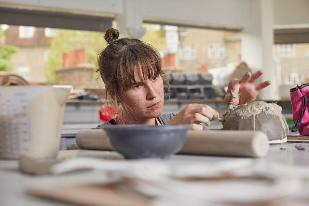Student working in a ceramics studio