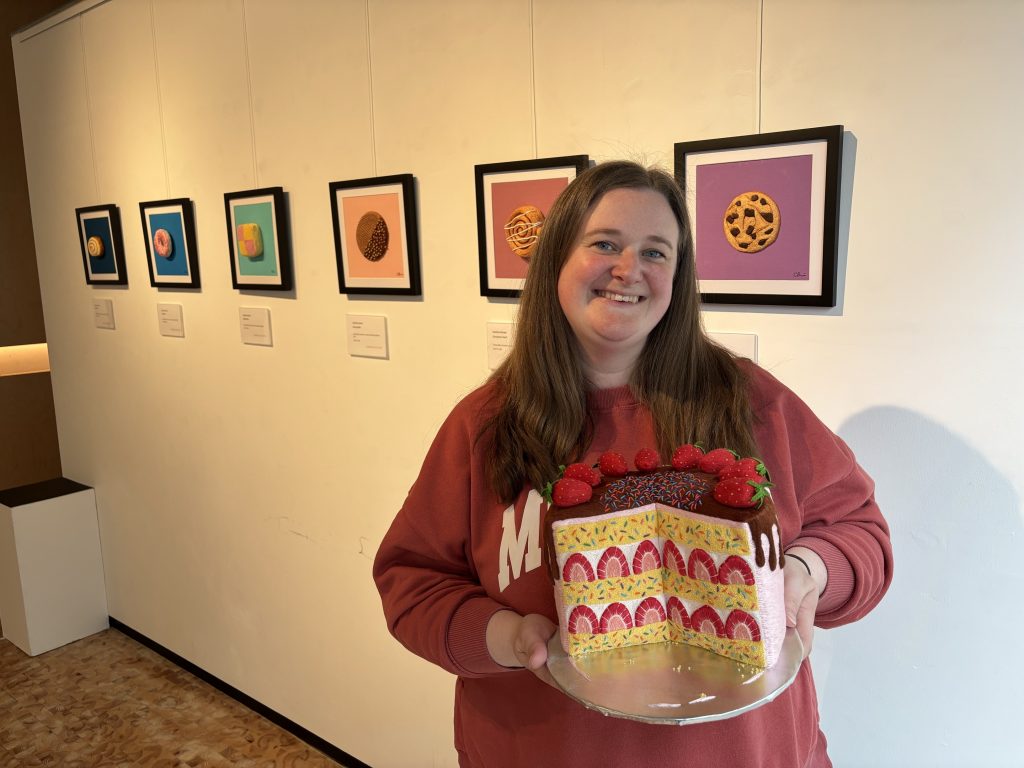 Student by a gallery of art works